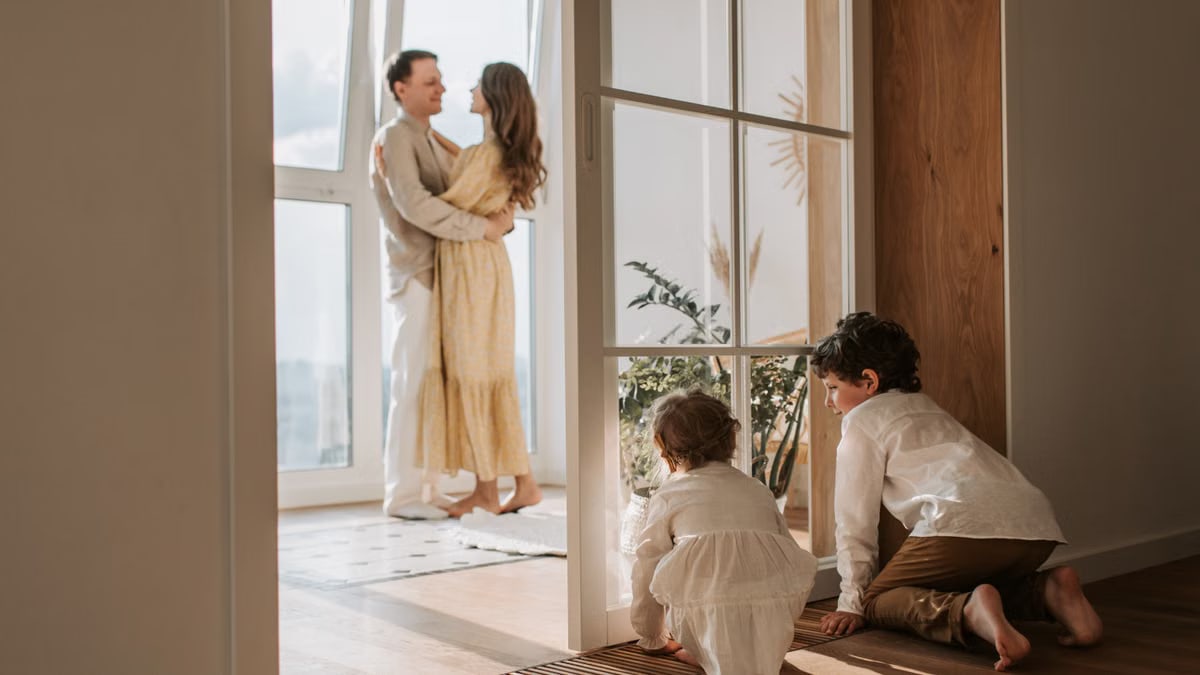 A joyful family moment indoors with parents and children enjoying a cozy home environment.